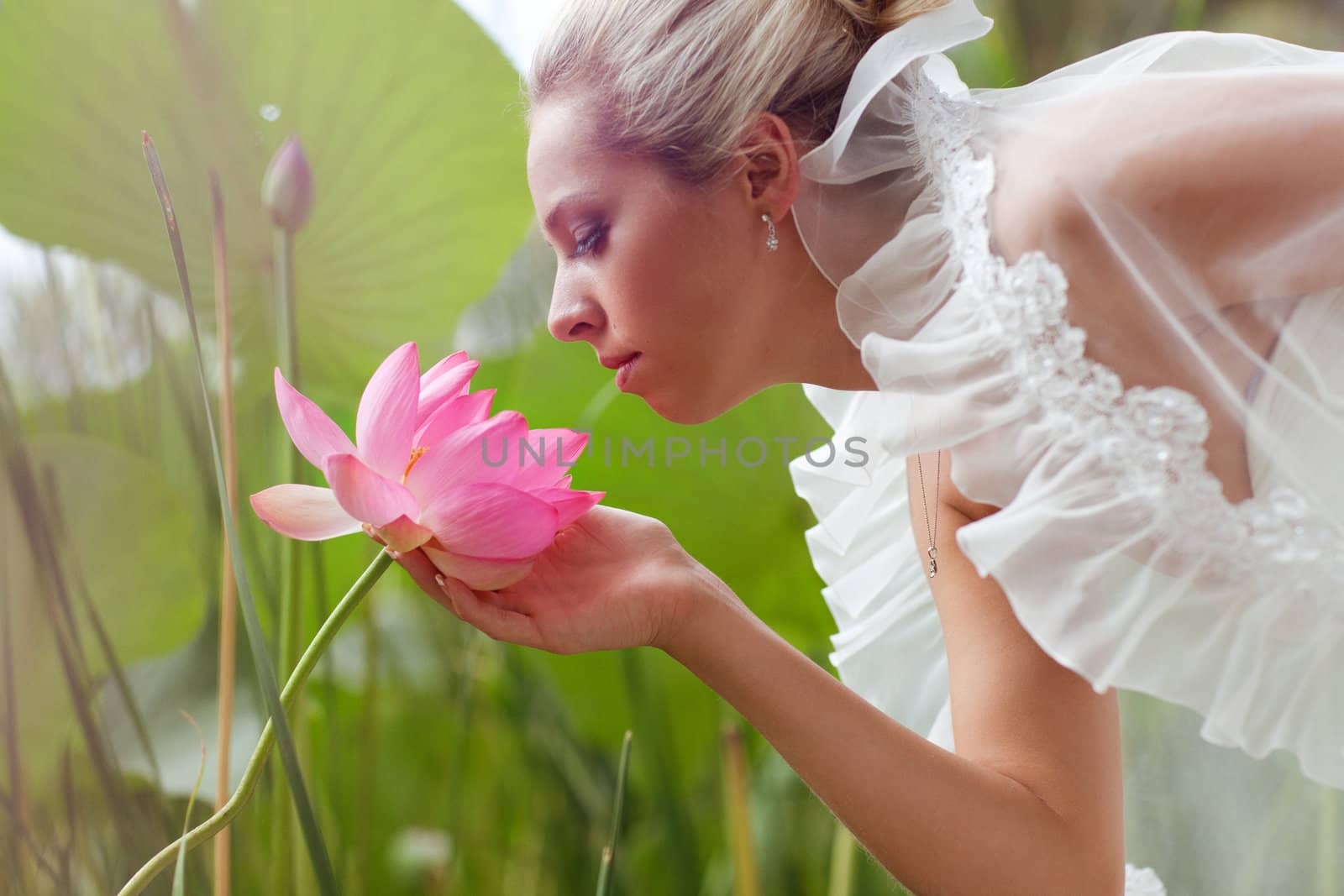 happy bride smelling a lotus flower