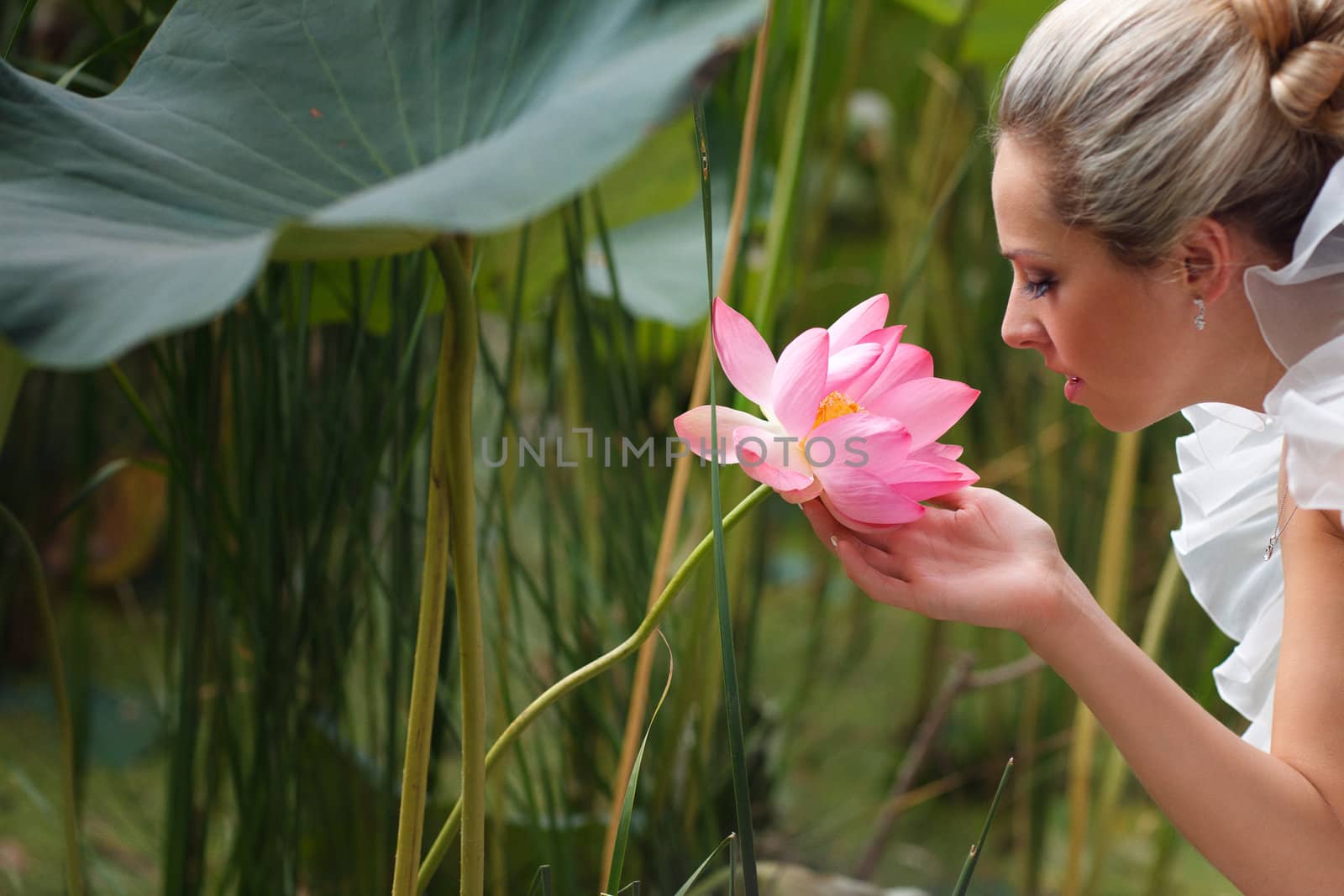 happy bride smelling a lotus flower