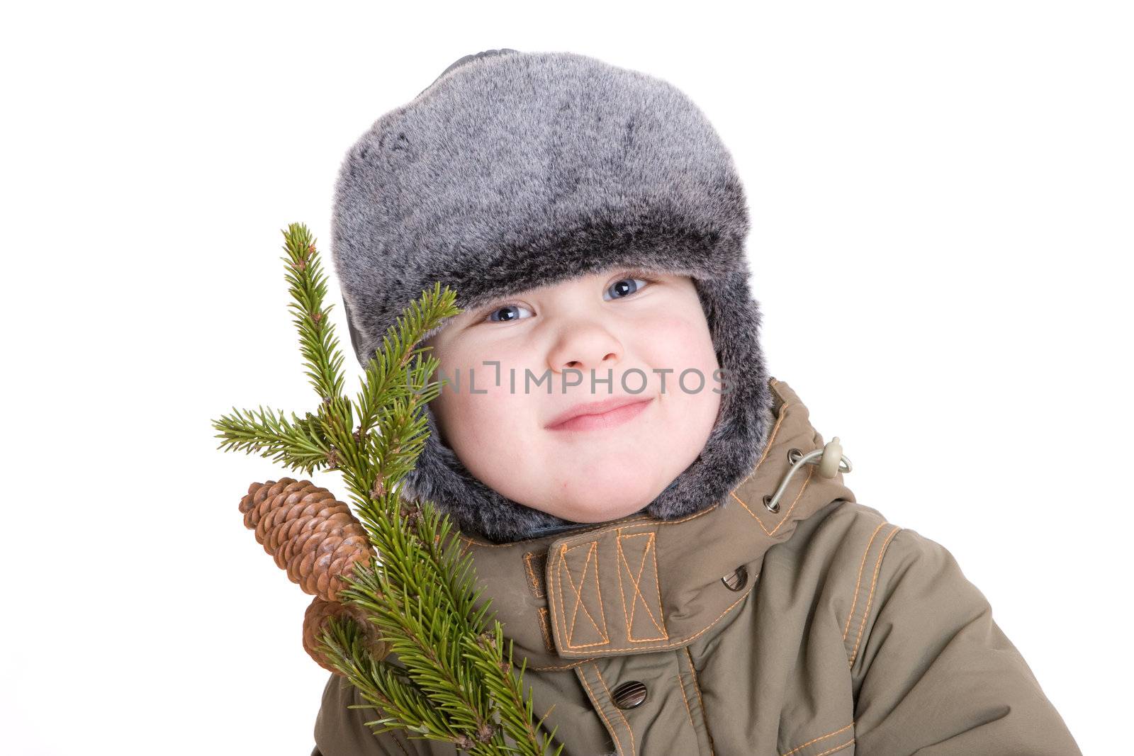 a smiling boy dressed for winter with a branch of fur tree with cones a smiling boy dressed for winter with a branch of fur tree with cones