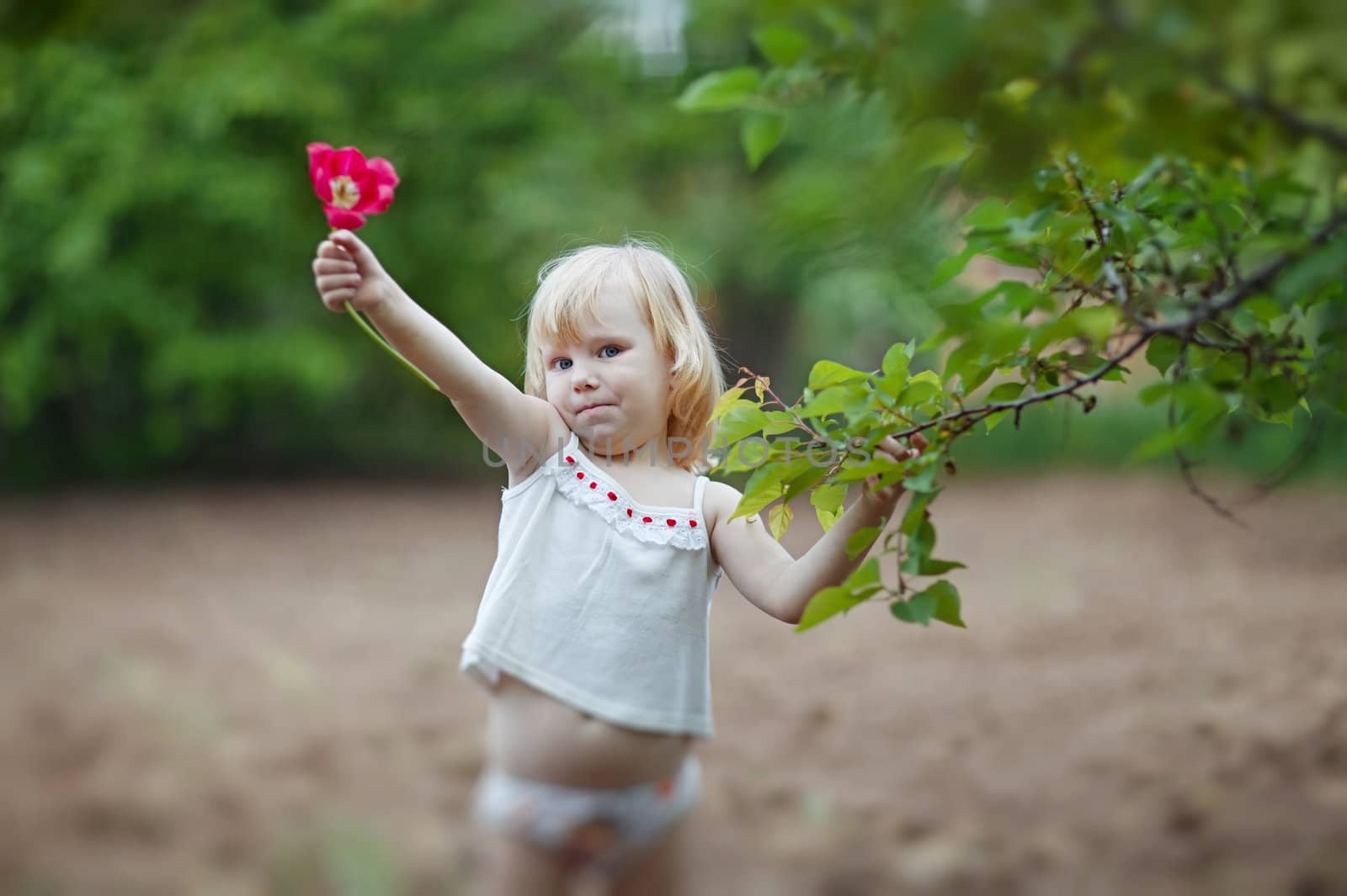 happy small girl with tulip by vsurkov