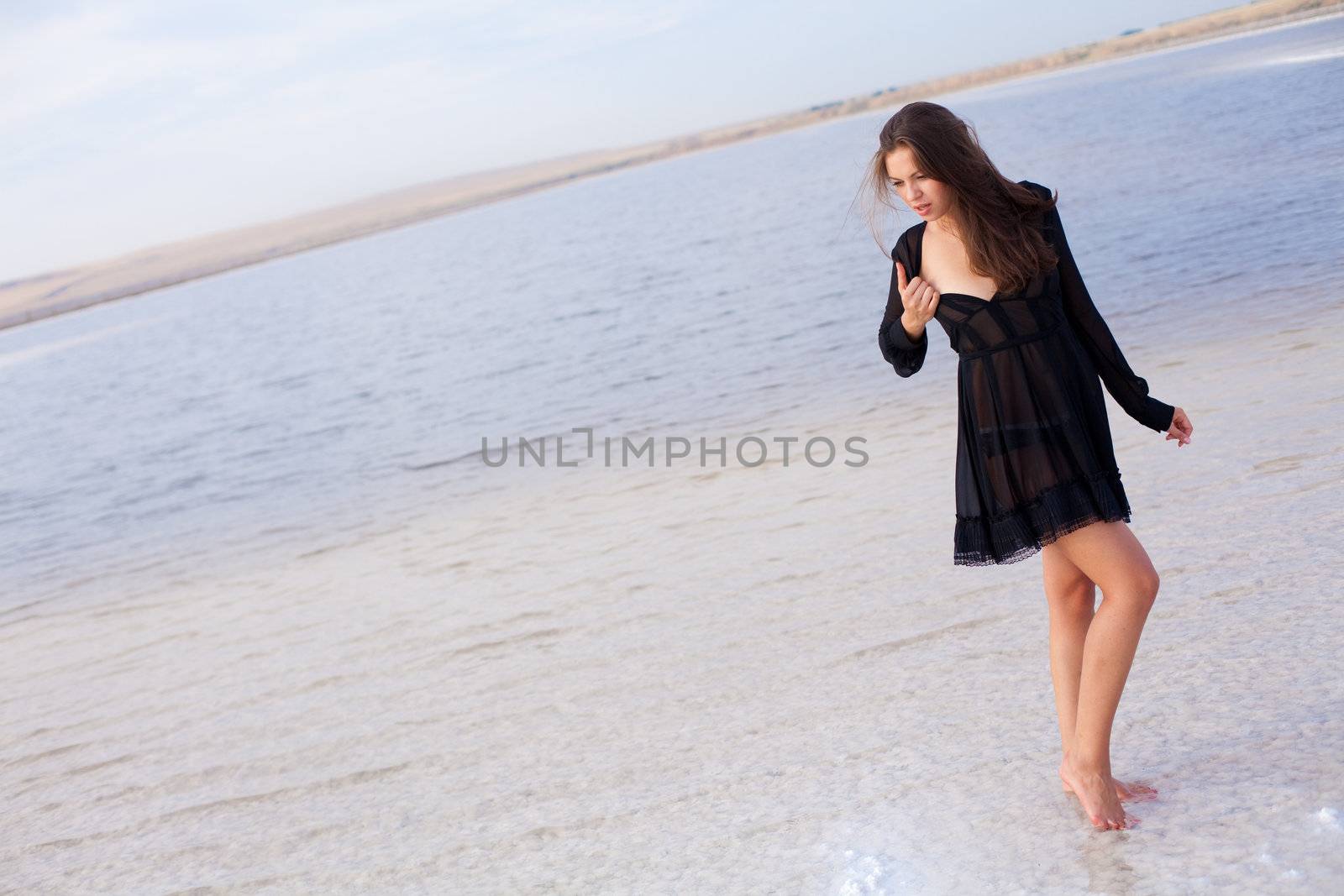 girl in a salt lake in a sunrise