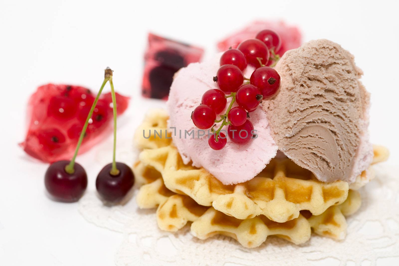 dessert consist of currant, ise-cream, cherry and waffles