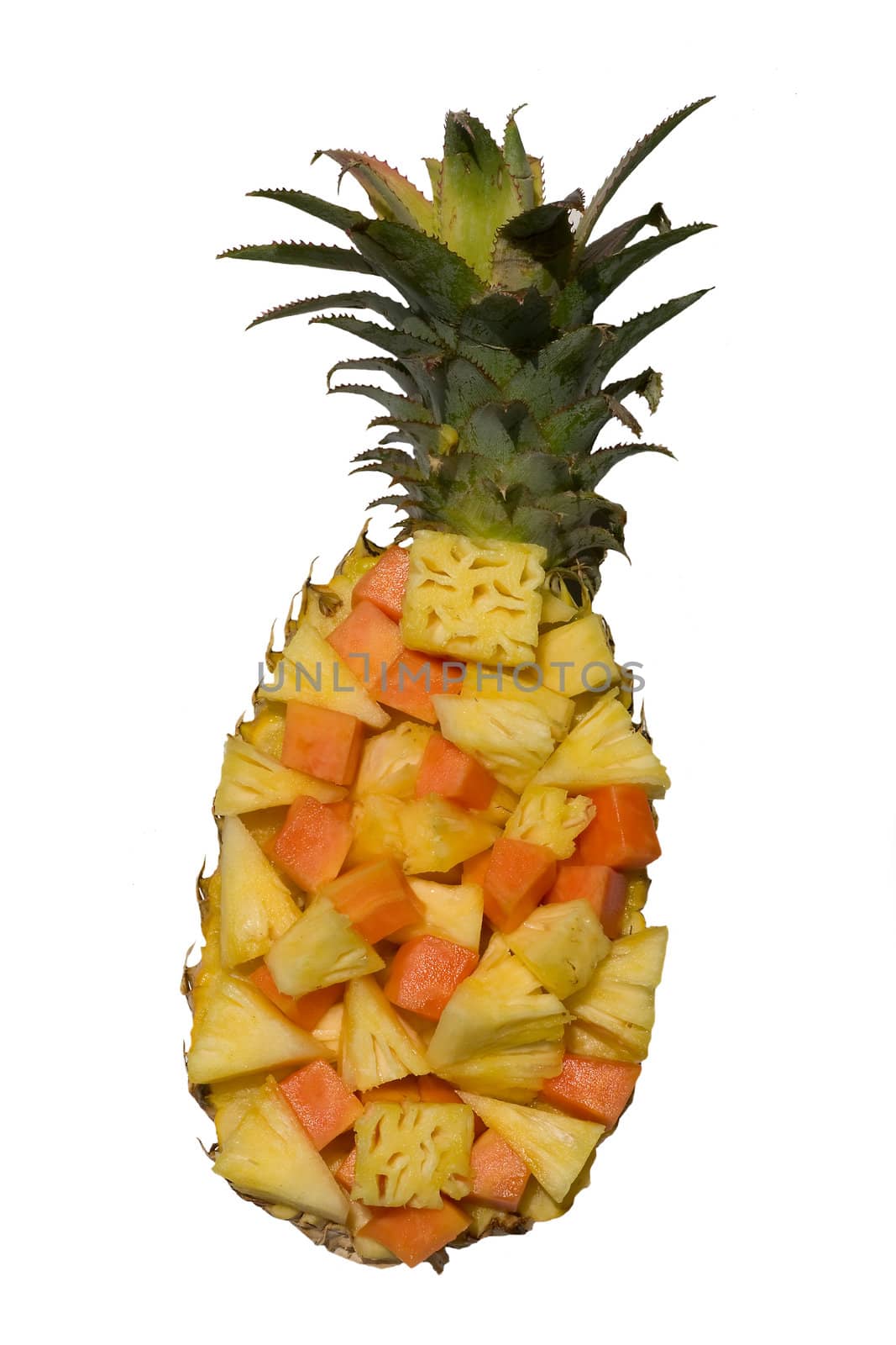Assorted exotic fresh fruits in a pineapple skin isolated on white