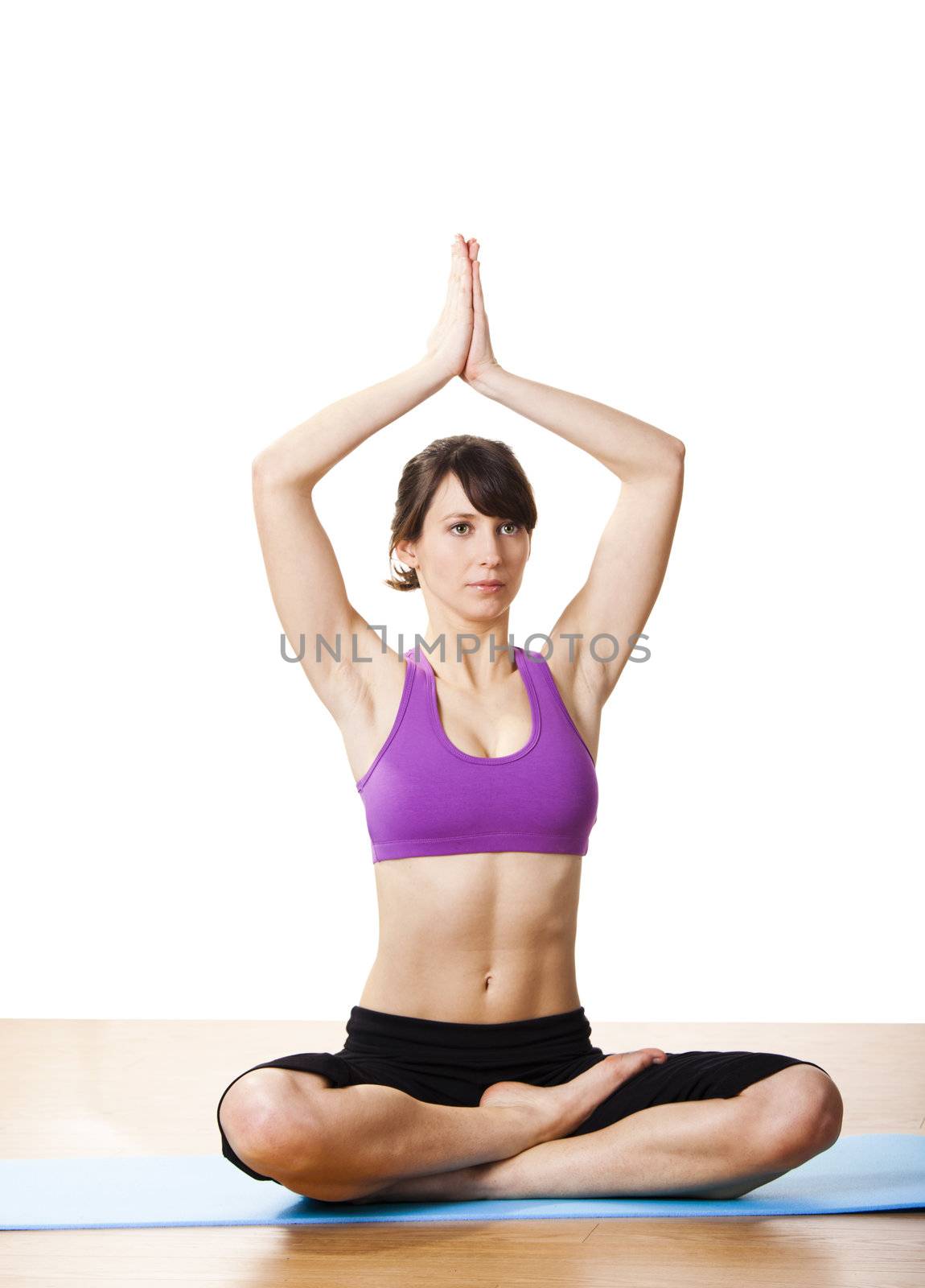 Beautiful and athletic young woman doing yoga exercises