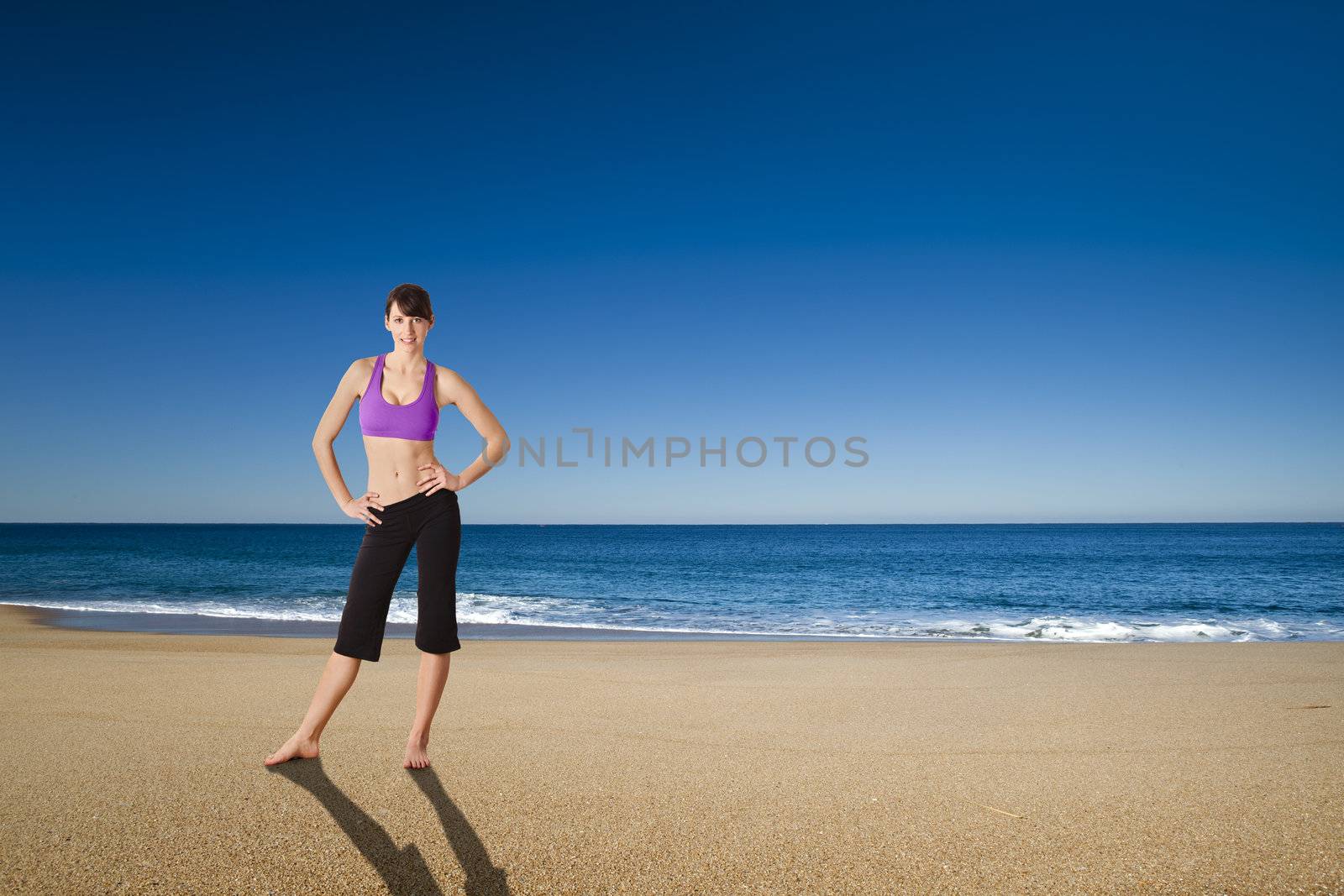 Beautiful athletic young woman in the beach