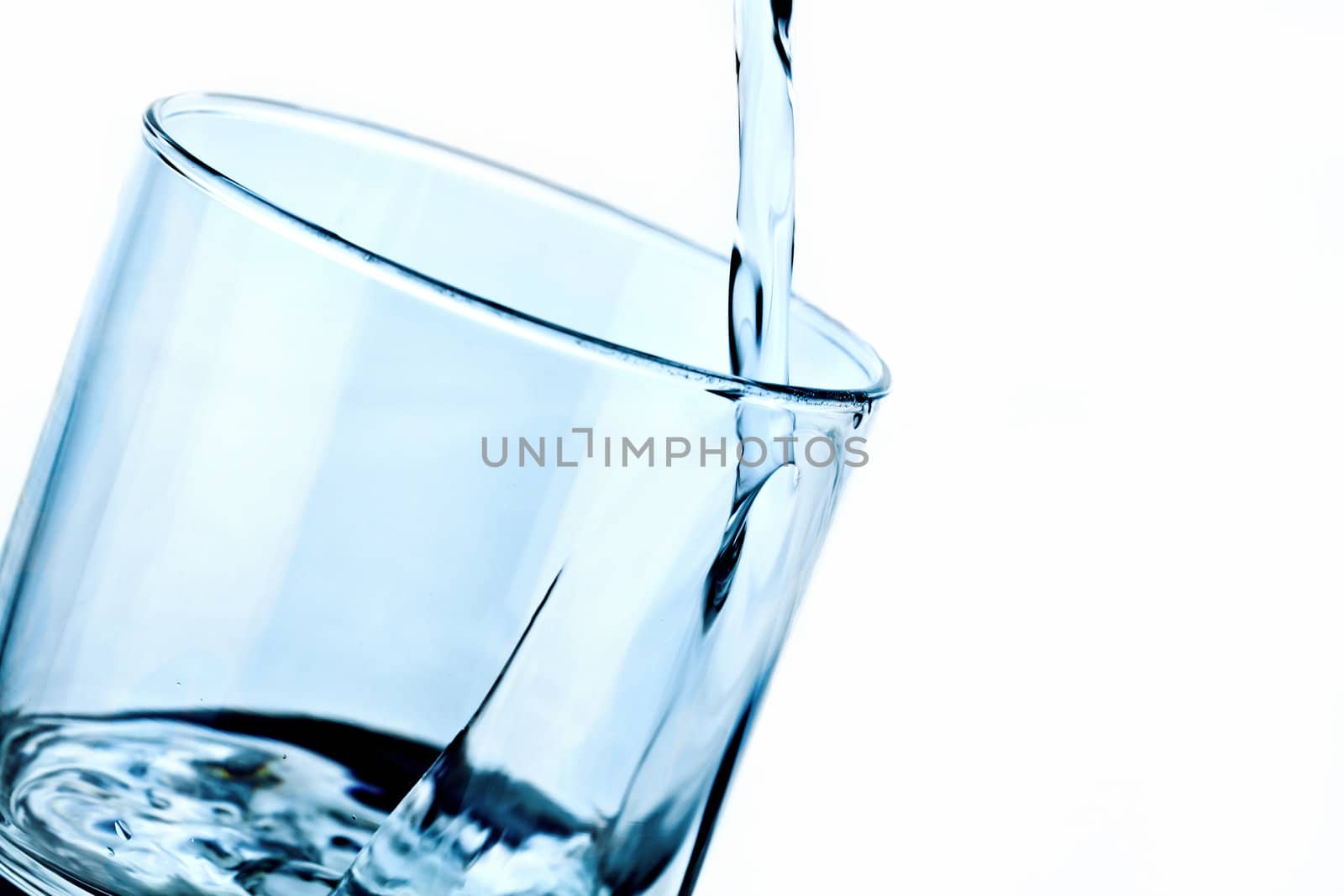glass with pouring water by oneinamillion