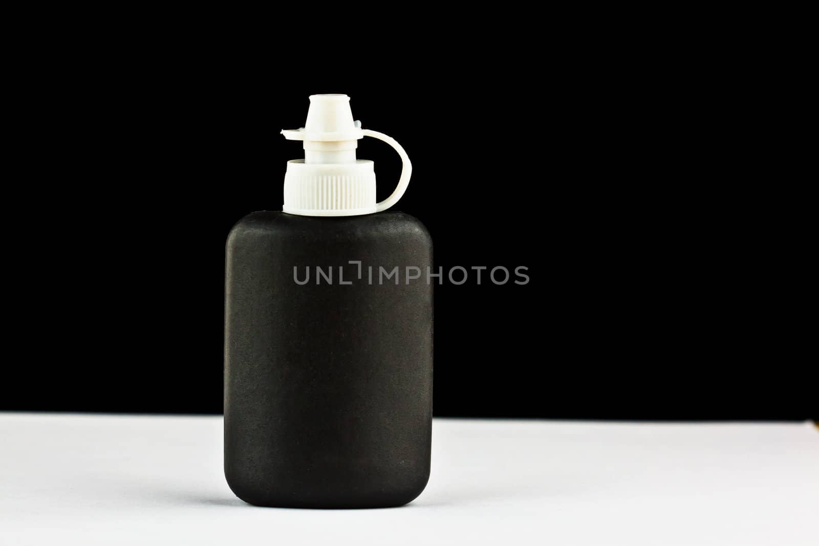 close up of a black cleaning bottle 