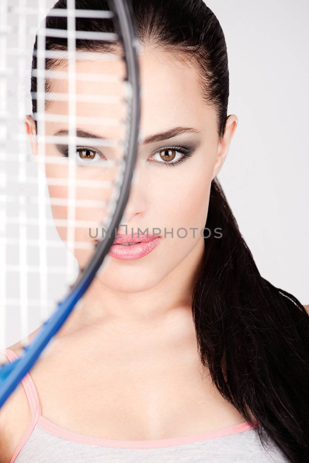 Pretty woman behind tennis racket