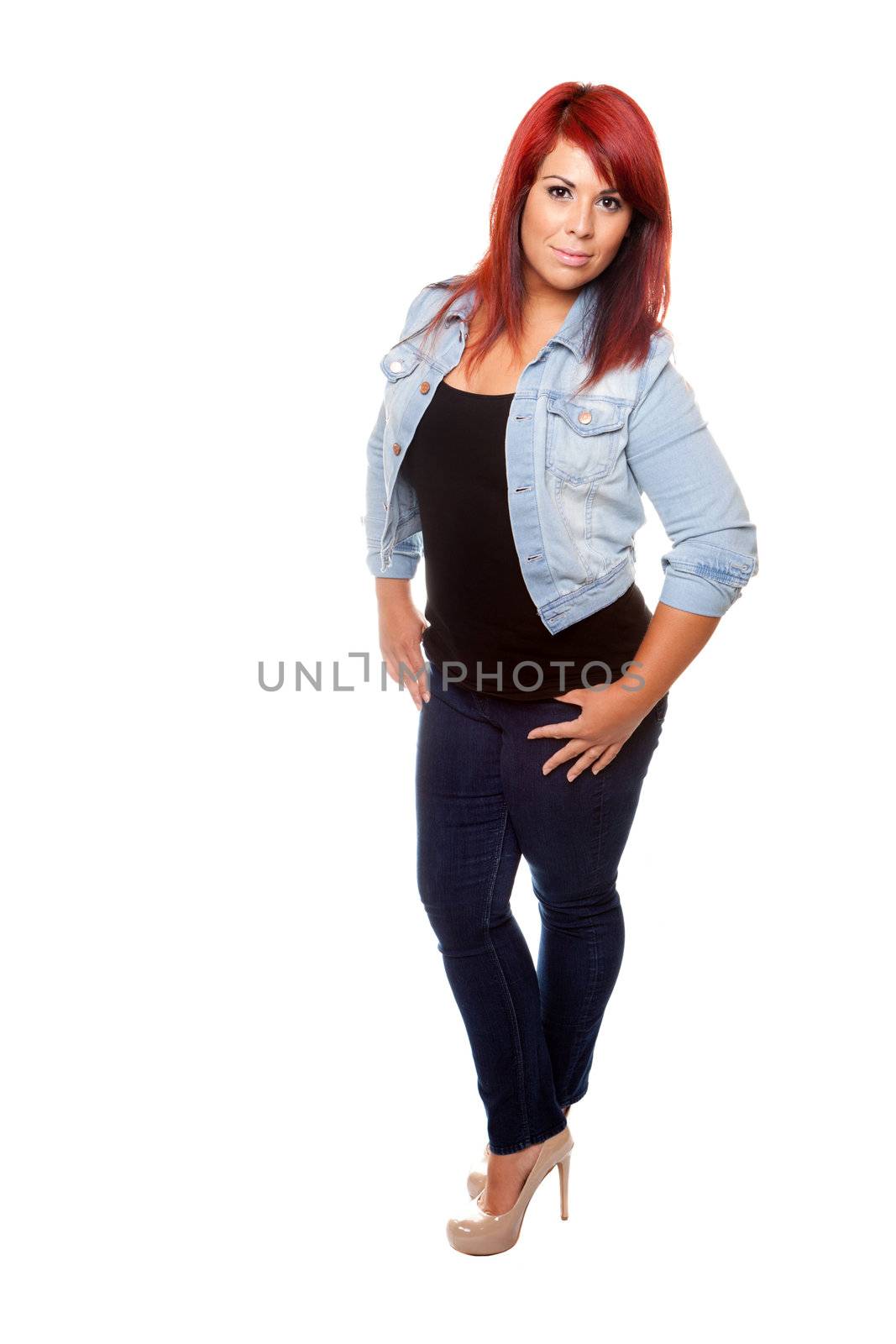 Young woman proudly shows off her physique wearing jeans over a white background.