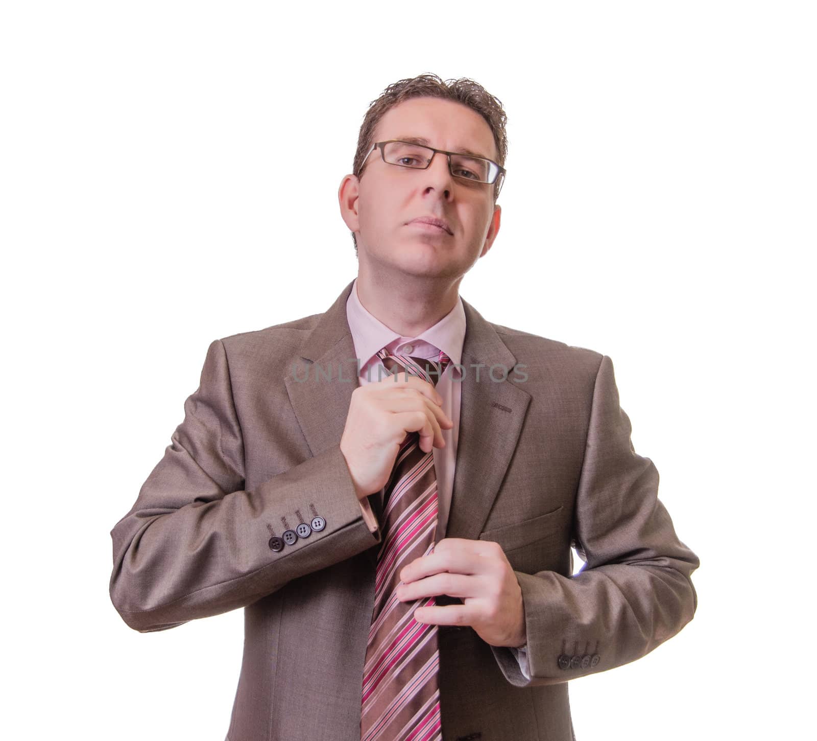Thoughtful businessman putting his tie on white background by doble.d
