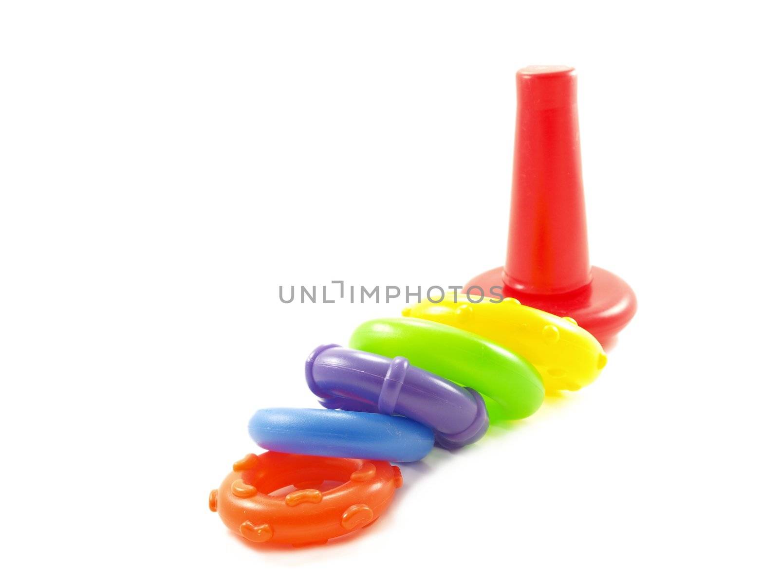 Colorful plastic pyramid toy isolated on white background by Arvebettum