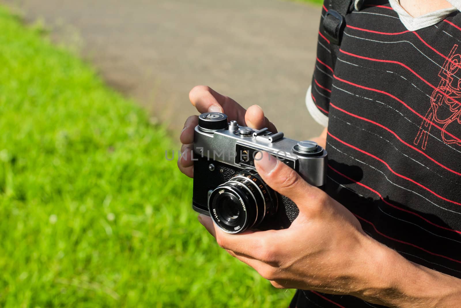 young photographer holding an old film camera