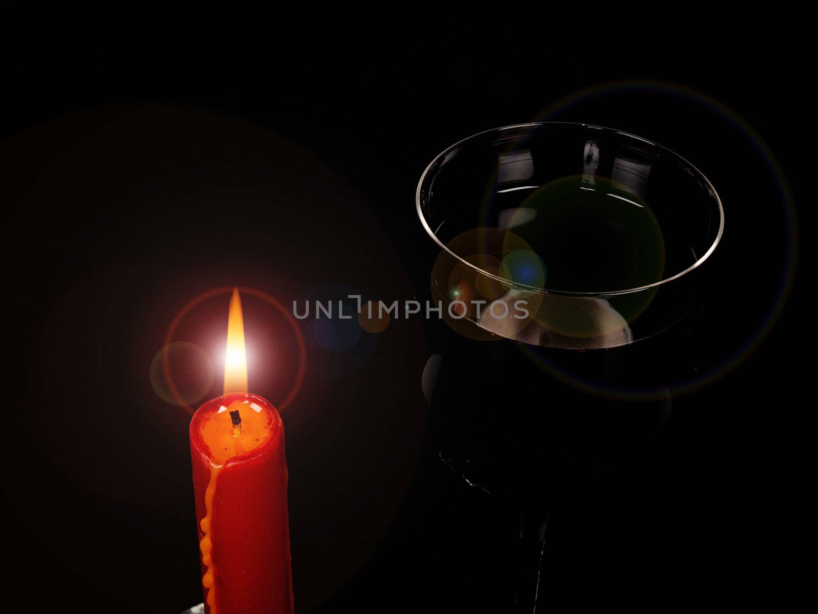 candle and glass of red wine
