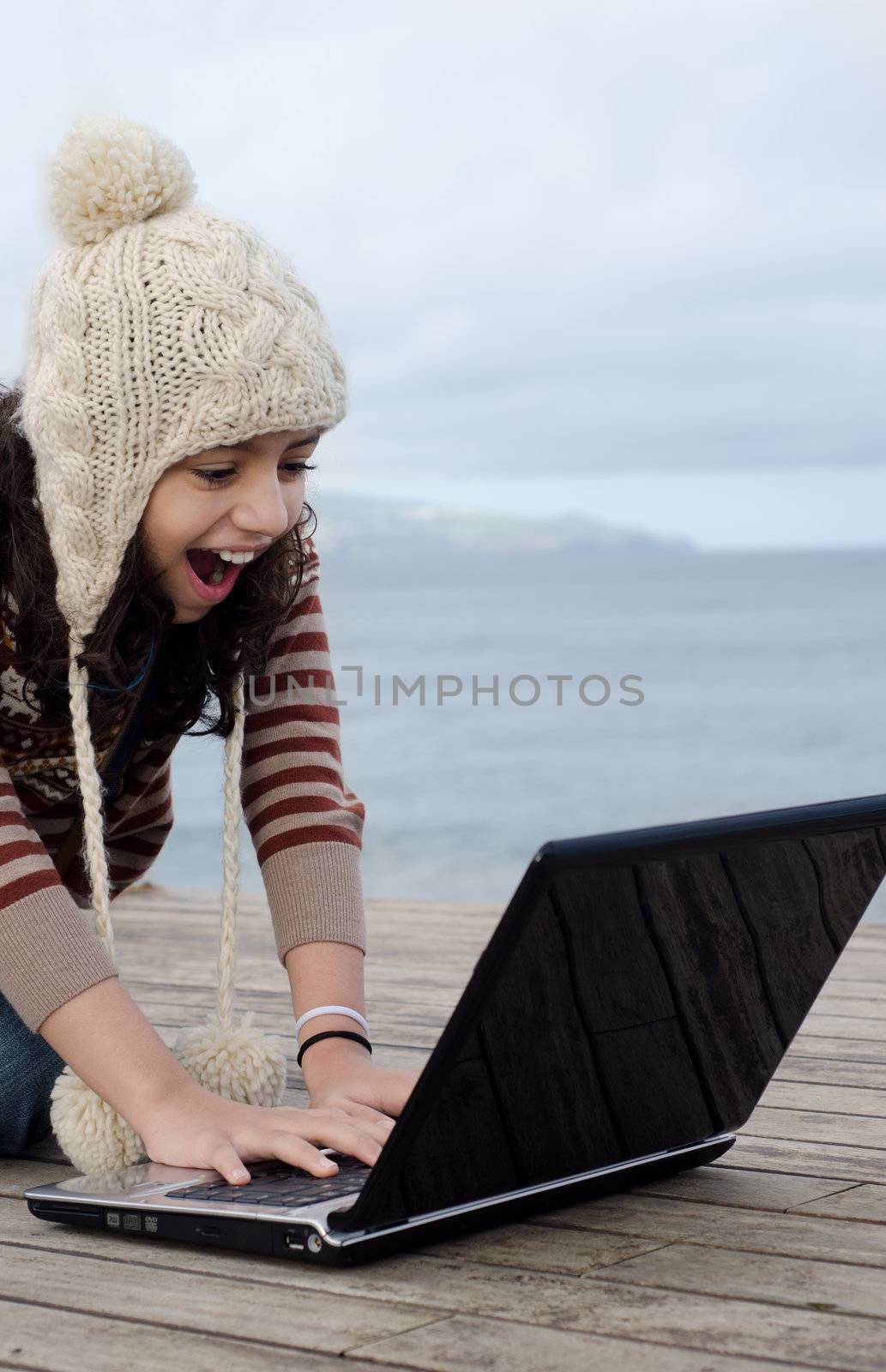 Having fun using the laptop close to the beach