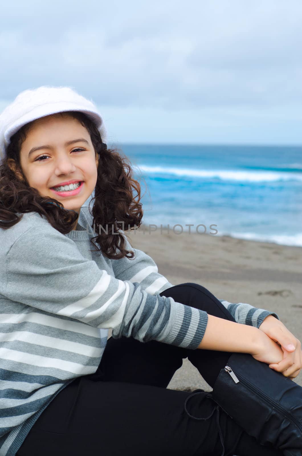 Cute child relaxing at the beach in modern style dress code







C