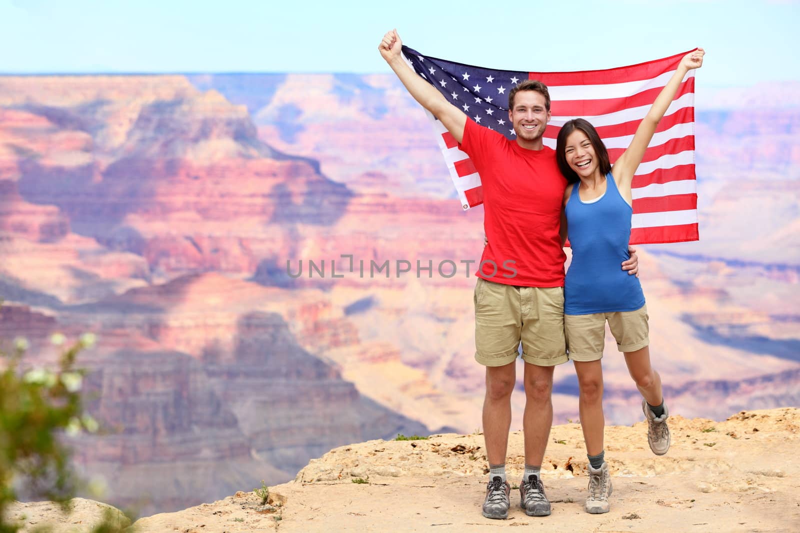USA travel tourist couple holding american flag by Maridav