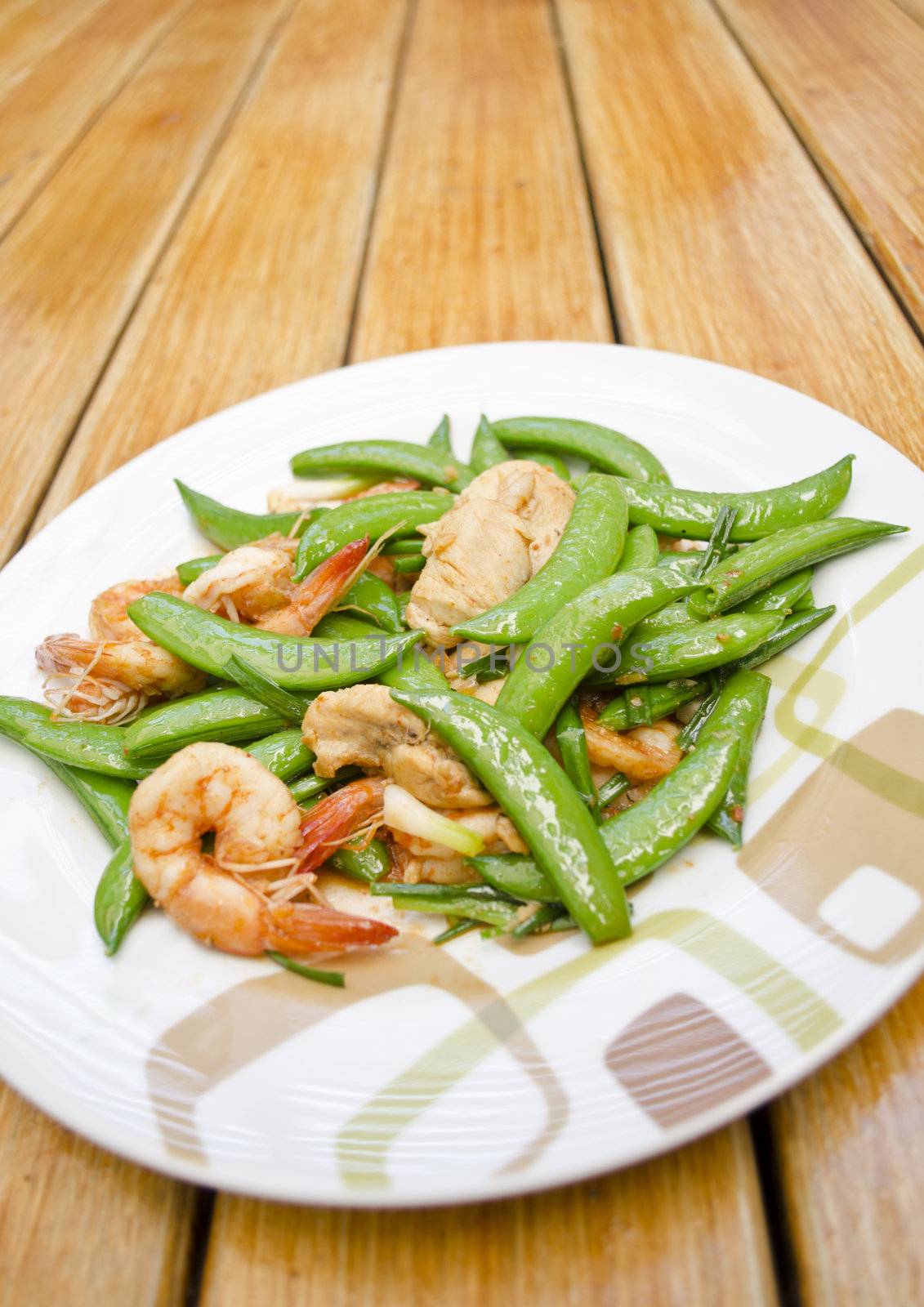 Thai-food Fried shrimp, pork and sweet peas. wood background.