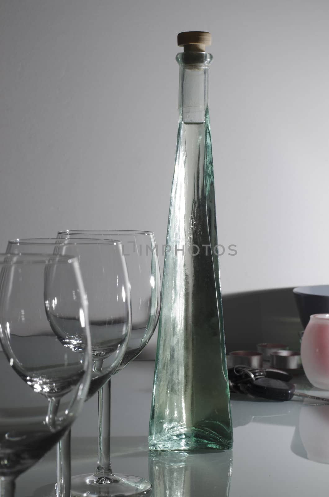 liquor bottle with glasses and miscellaneous object on bar stand
