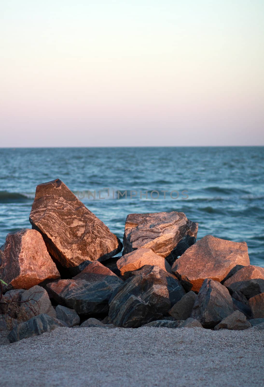 Pile of rocks by the sea on a summer evening by pt-home