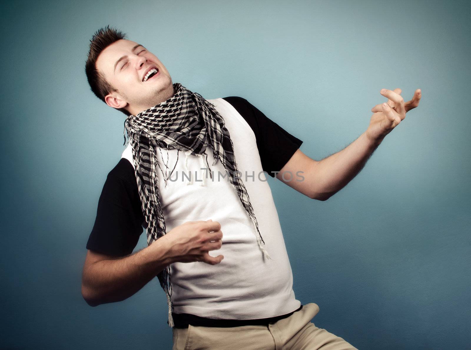 Young man having fun mimicking a guitar