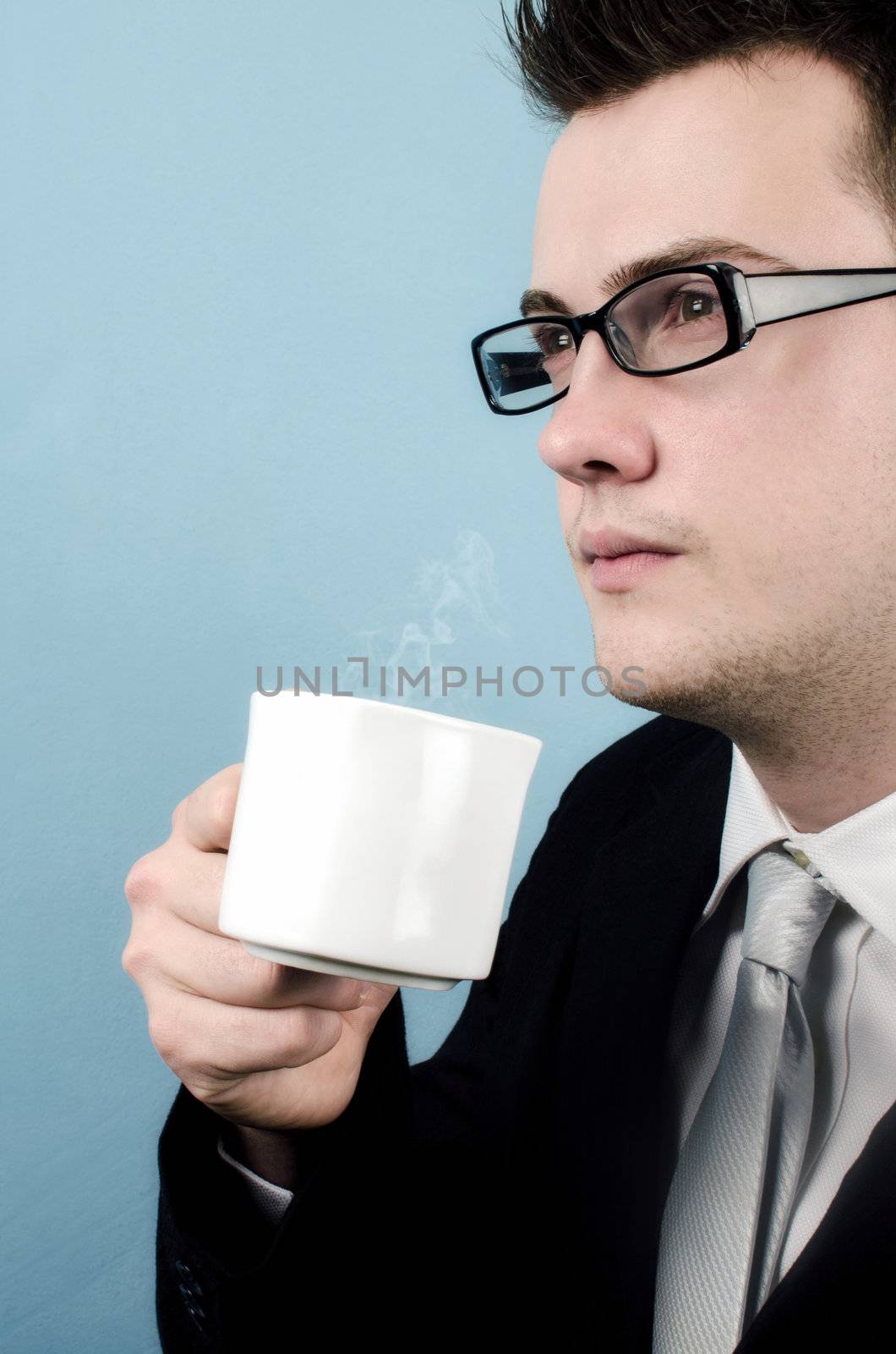 Young businessman taking a coffee break