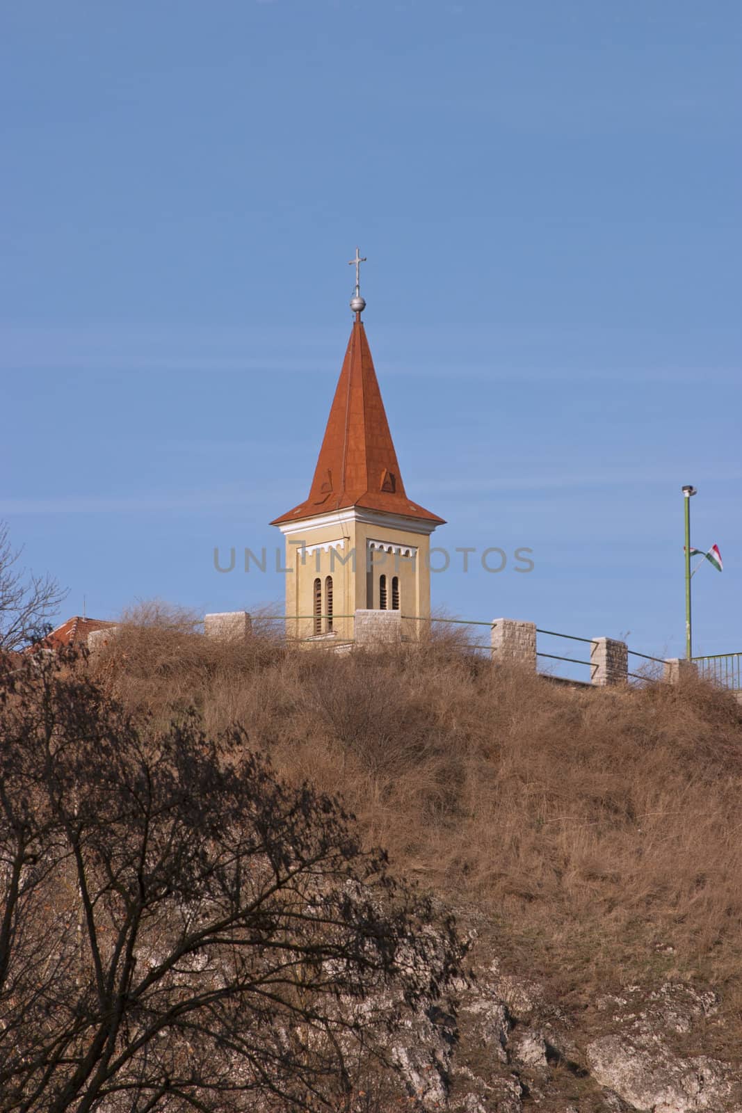 A church tower steepens on the top of a hill