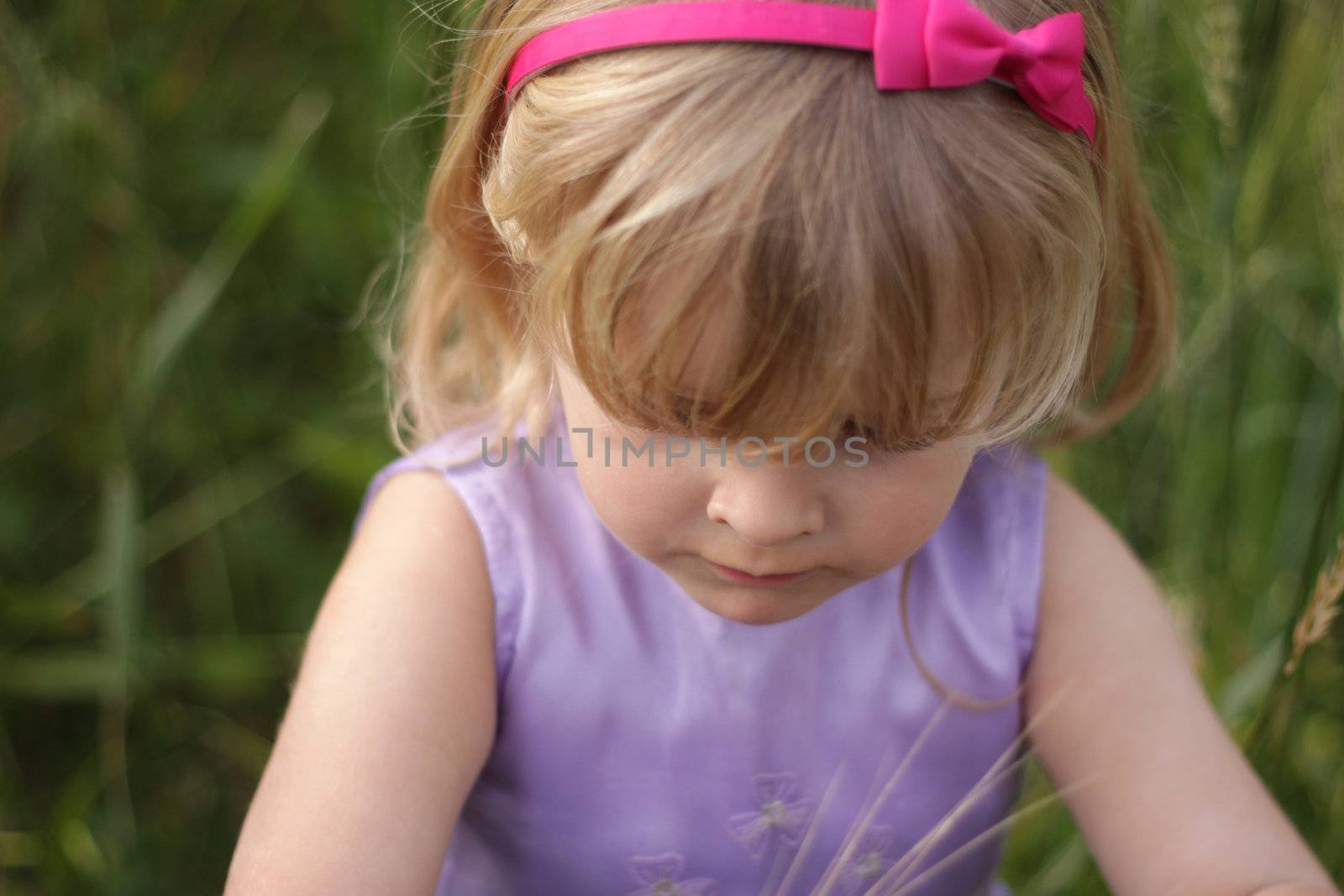 3 year old girl with blond hair and a bright pink hairband