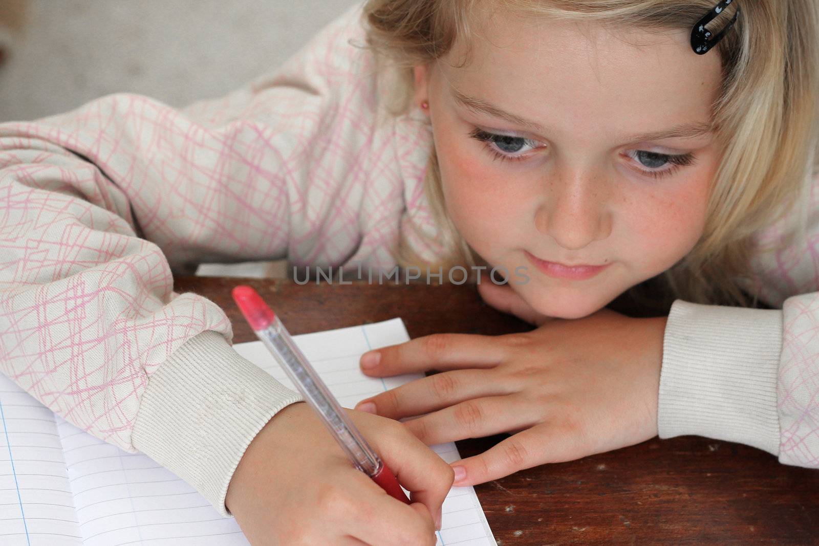 Girl writing in notebook by annems