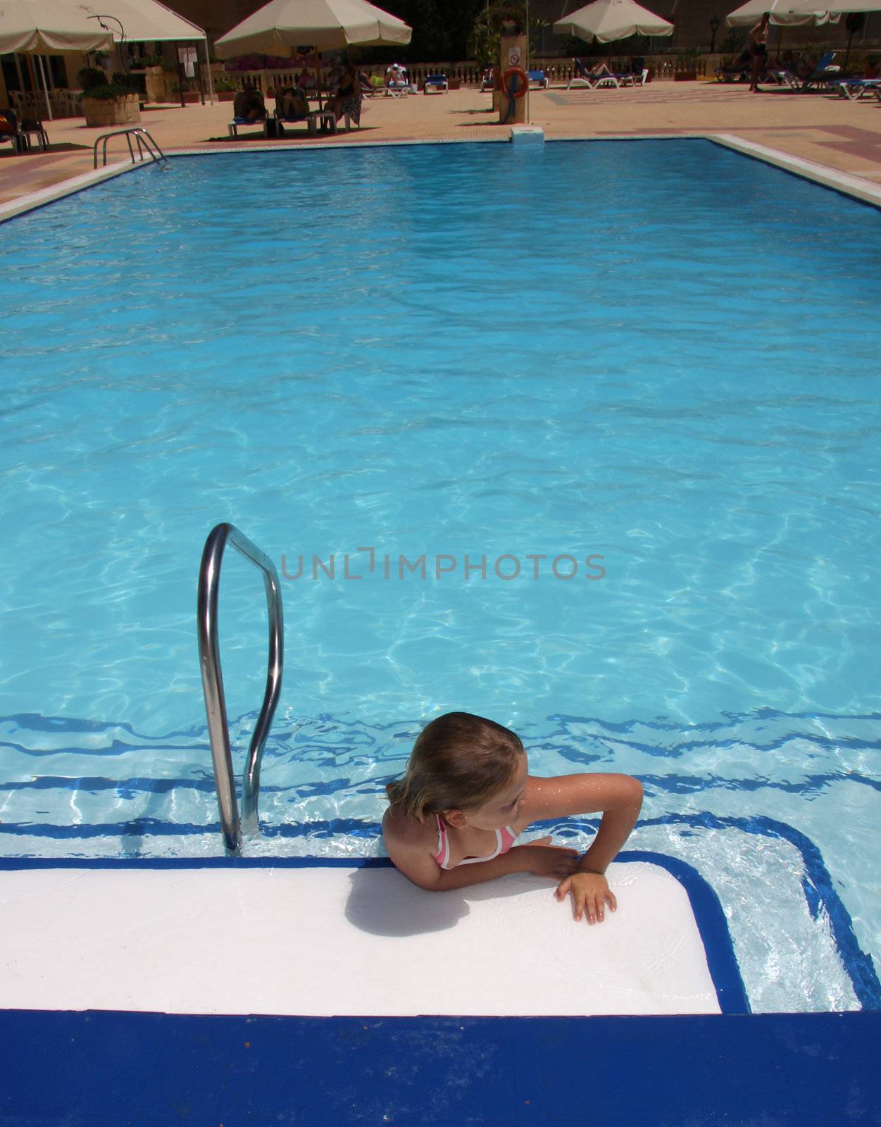 Girl resting in a blue swimmingpool