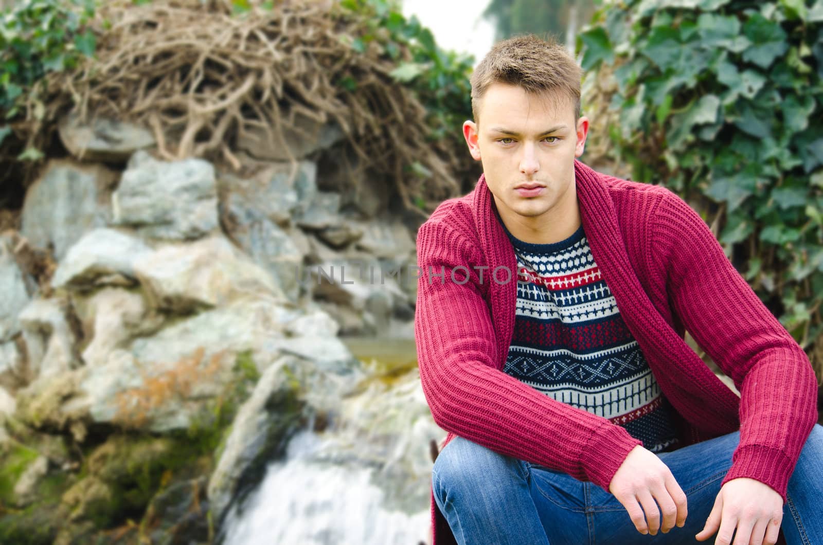 Portrait of handsome young man with winter clothes and blue jeans by artofphoto