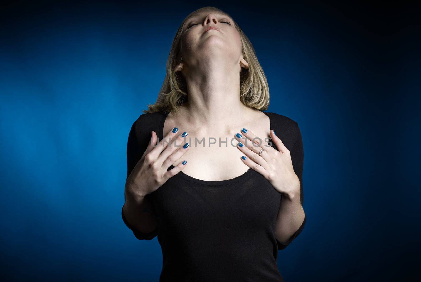 Stuido shot of young attractive woman on blue background