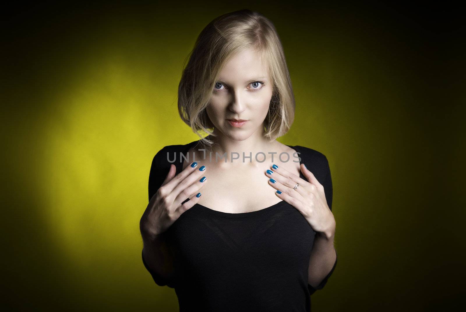 Stuido shot of young attractive woman on yellow background