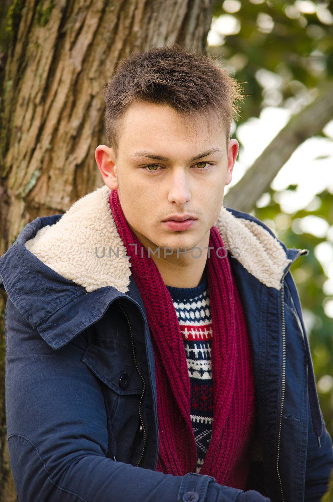 Portrait of handsome young man with winter clothes outdoors