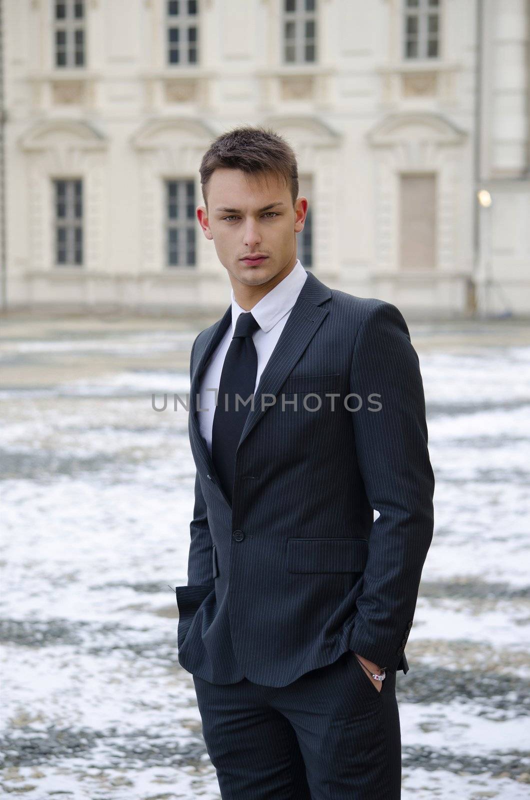 Good looking young man and elegant palace with snow by artofphoto