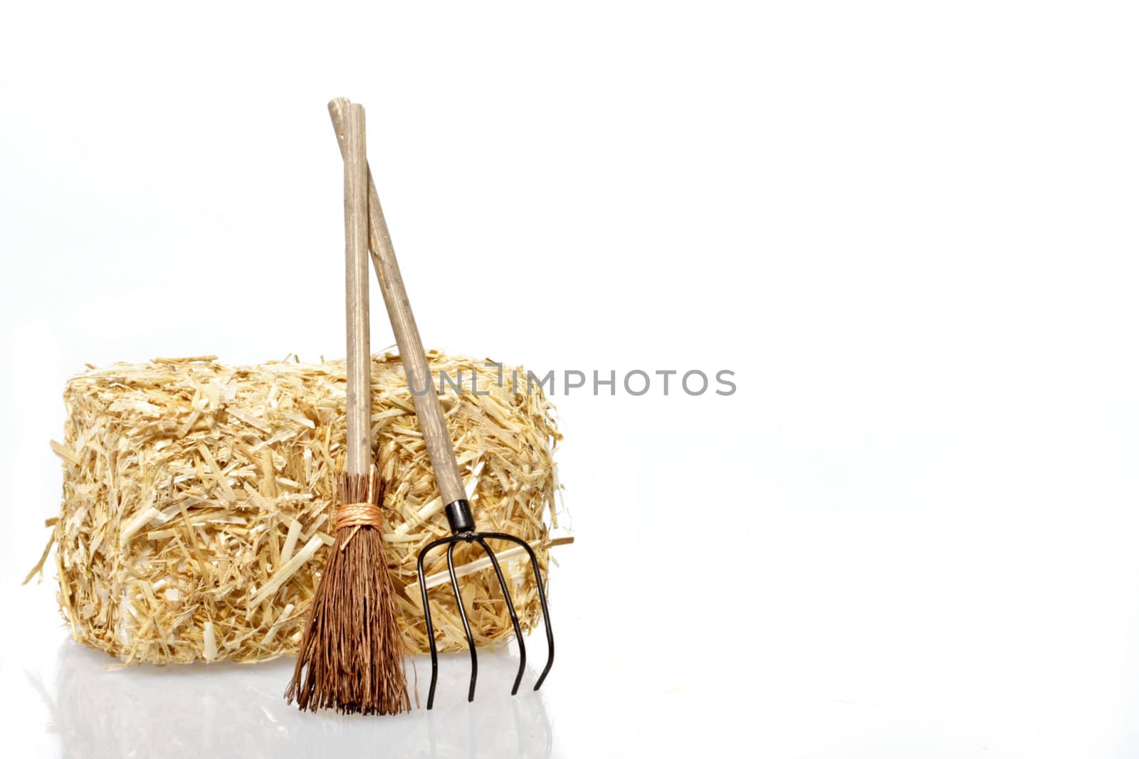 Hay bales with tools on a white background