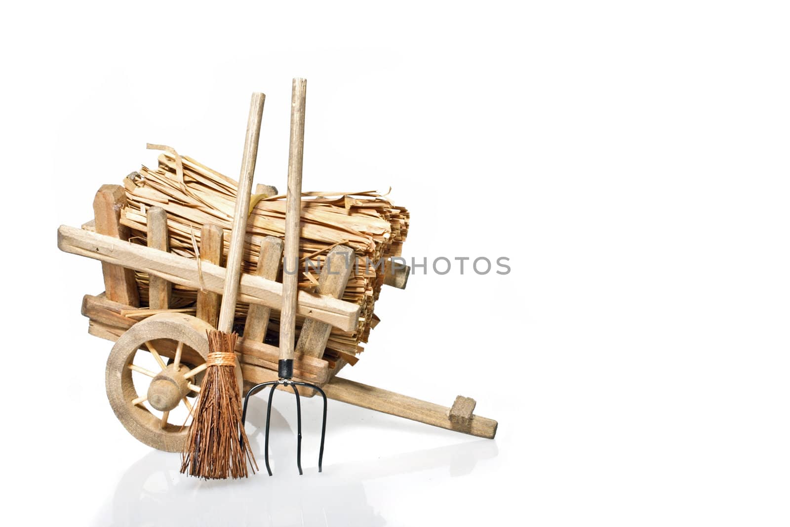 Old handcart with straw and tools
