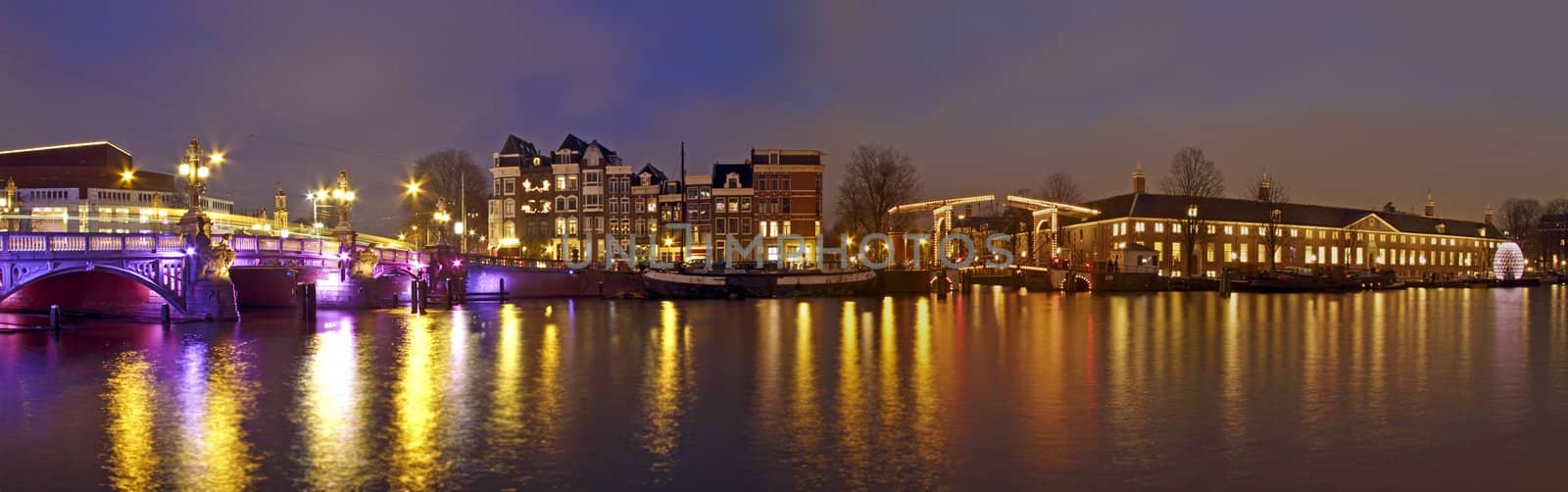 Panorama from Amsterdam innercity with the Amstel in the Netherlands by night