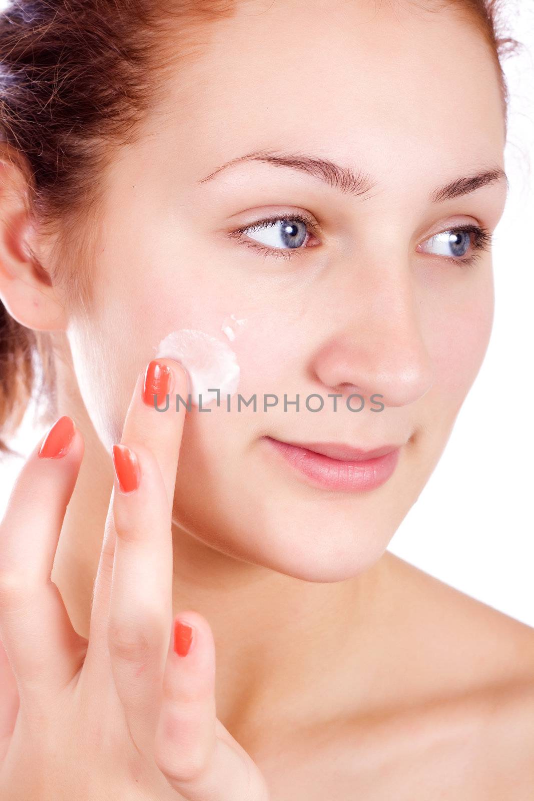 Attractive girl applying face pack.
