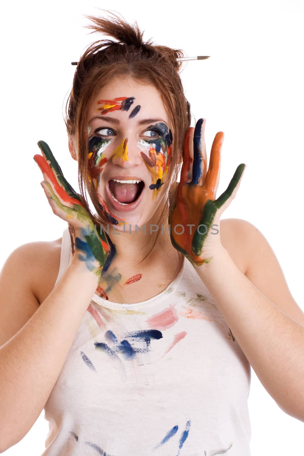 beautiful astonished girl with hands in the paint isolated