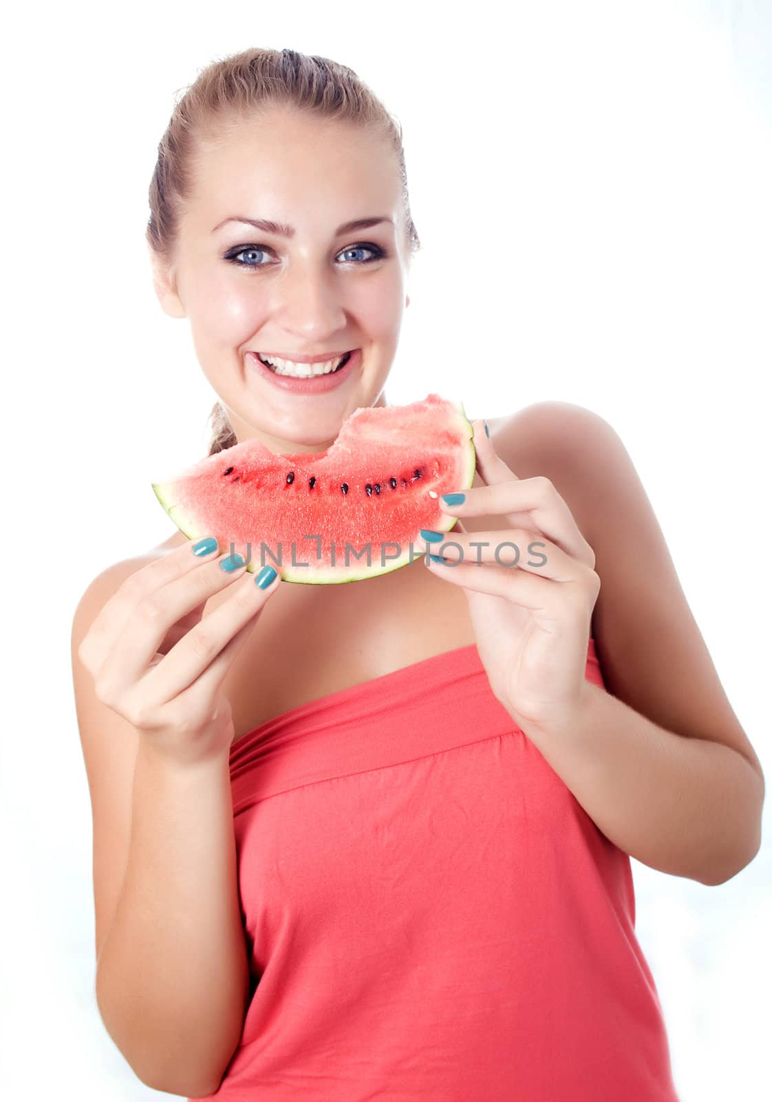Woman against white background taking a bite of watermelon.