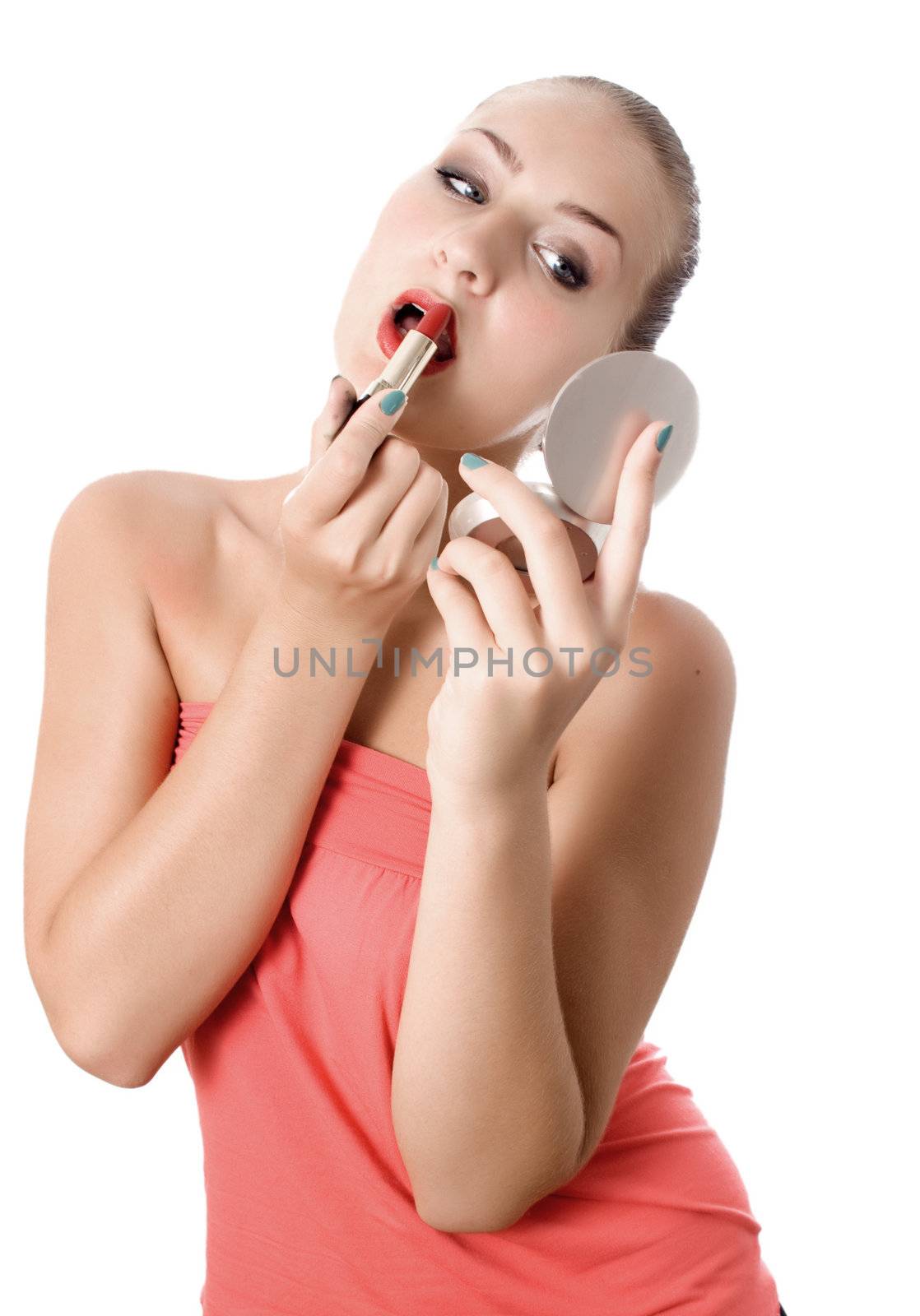 beautiful young girl making up her lips with lipstick