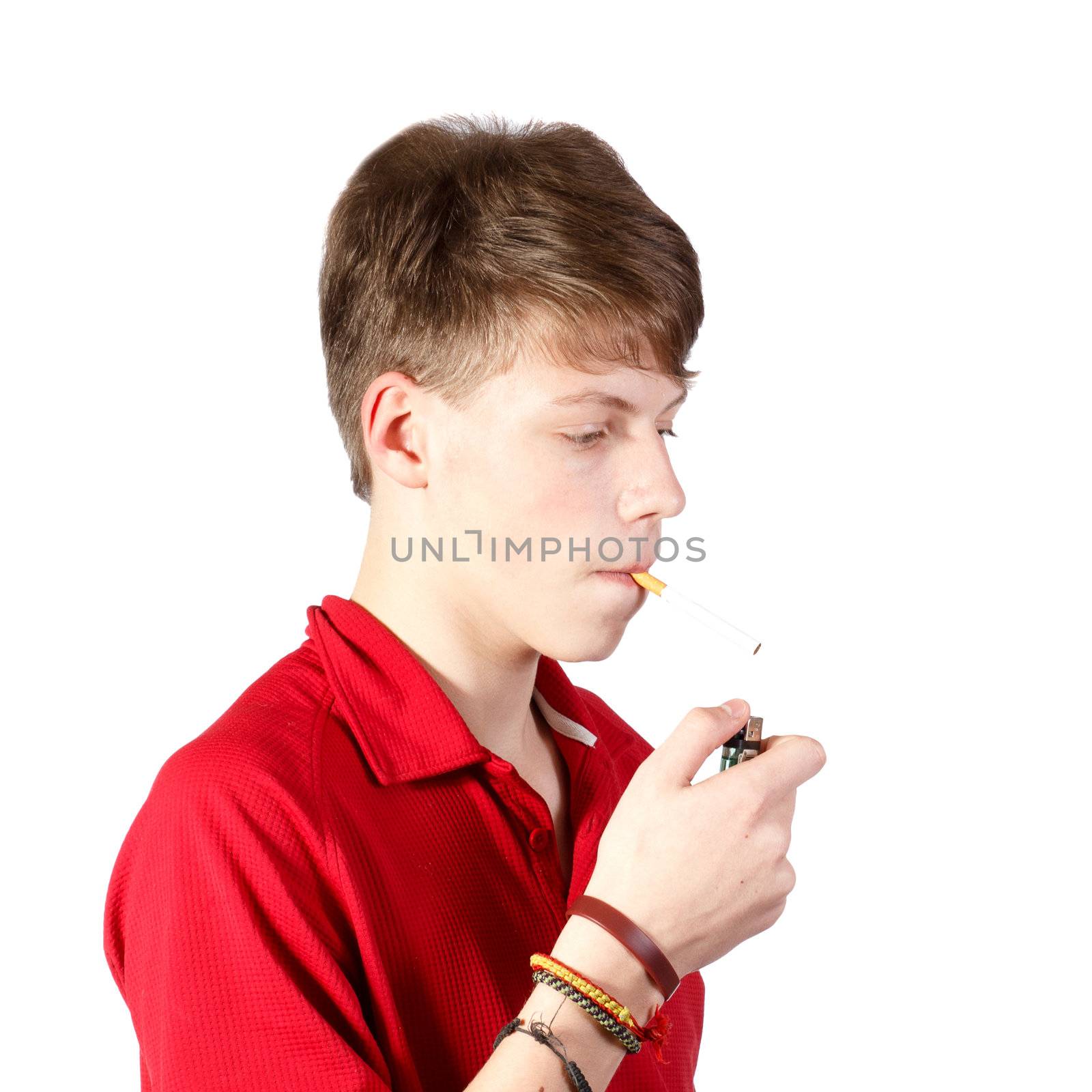 a teenage boy trying to smoke a cigarette against white background