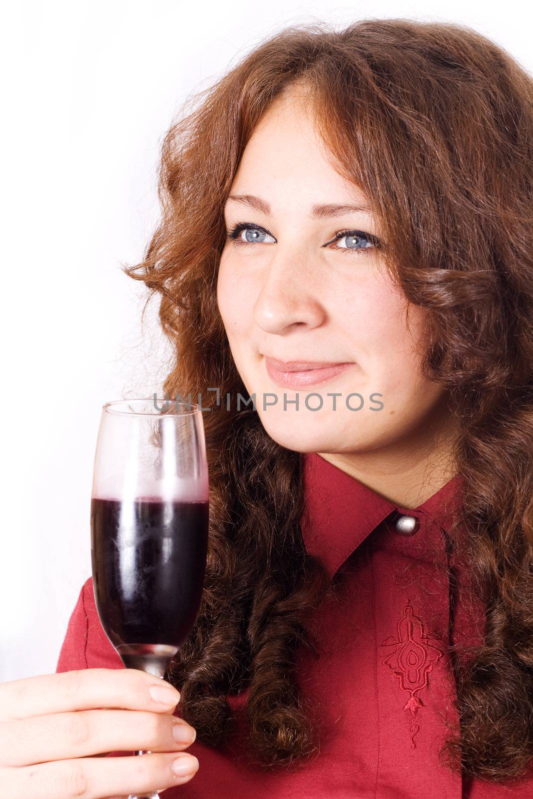 Closeup of beautiful female lips drinking wine from a glass with dewdrops on it.