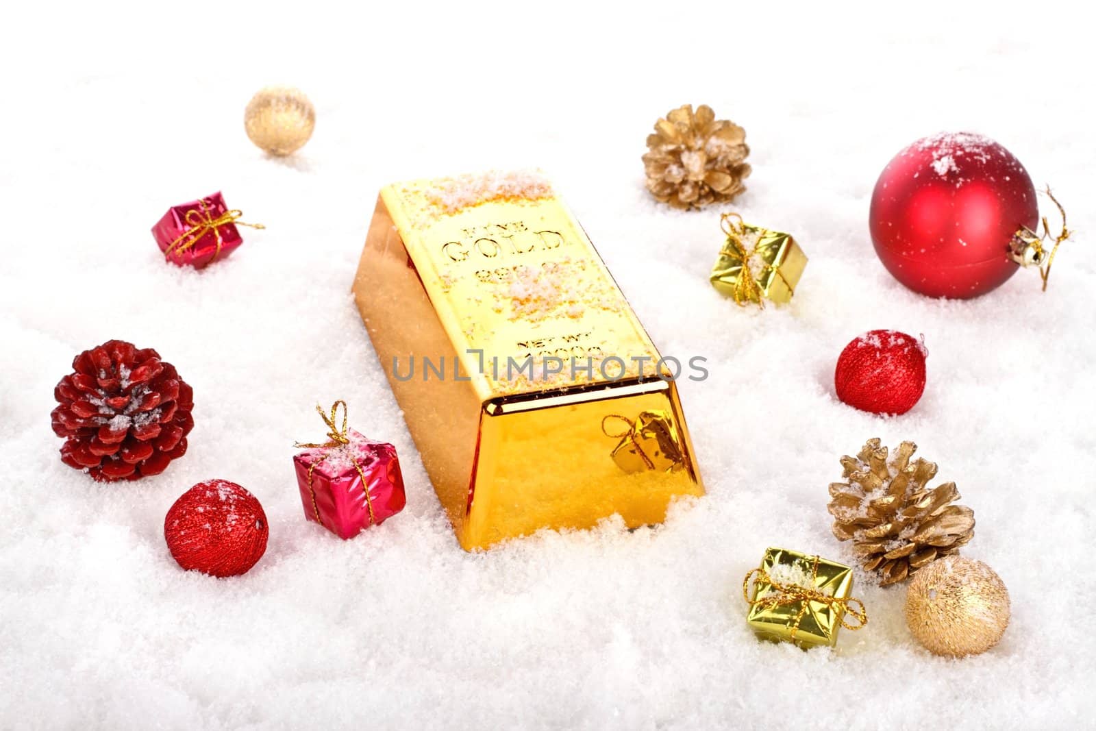 Golden bar as christmas present in the snow with ornaments