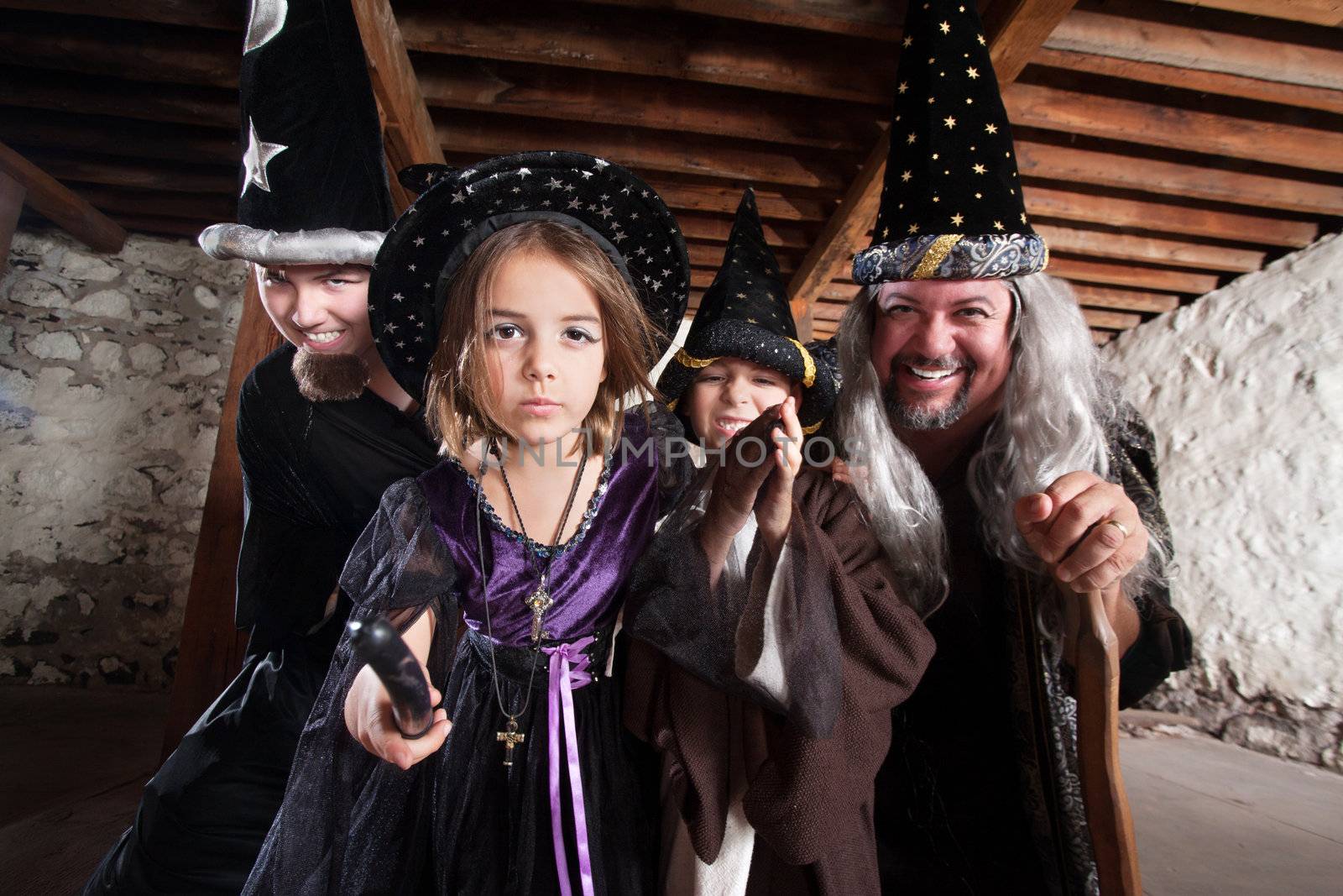 Magician father and children casting spells in a basement