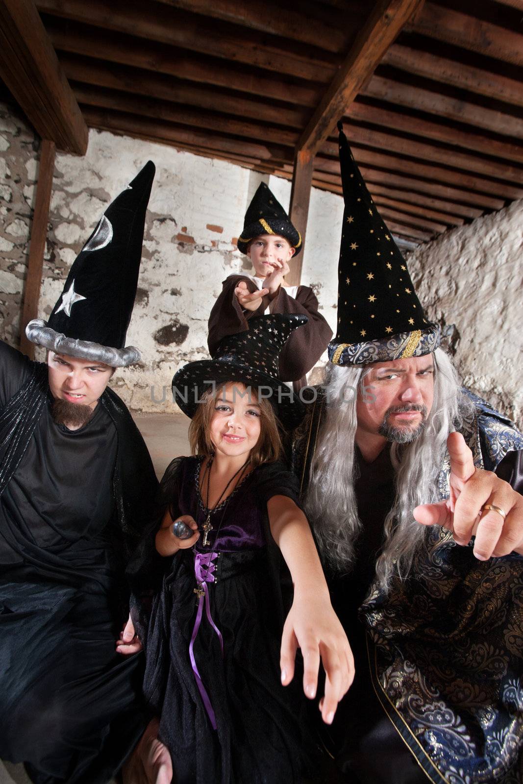 Sister and brother wizards casting spells with their father