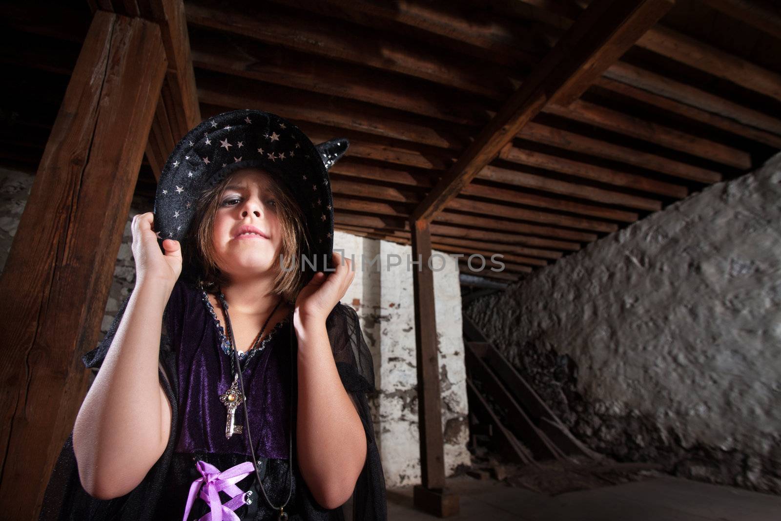 Young female witch pouting and pulling down her hat