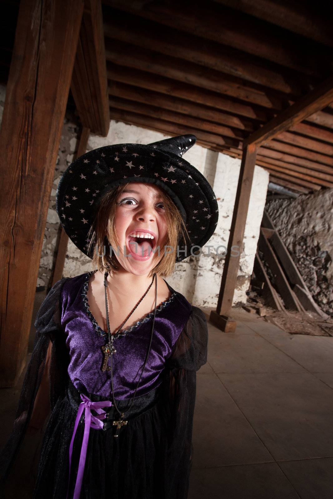 Screaming young female witch with hat and purple dress