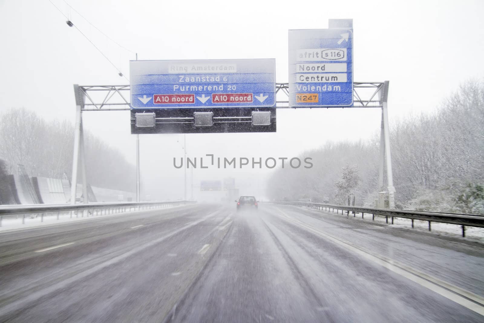Driving in a snowstorm on the highway near Amsterdam in the Netherlands