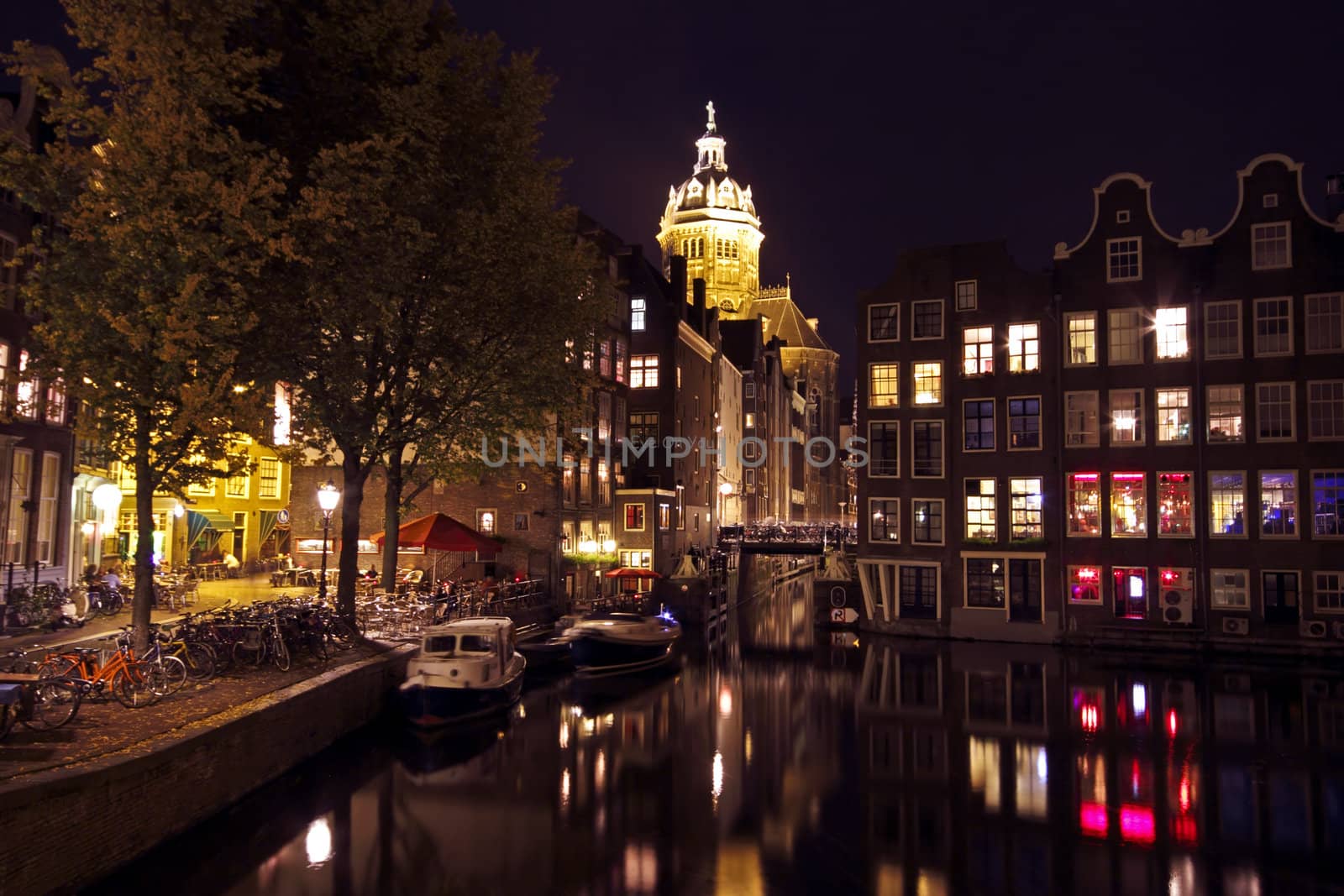 City scenic from Amsterdam in the Netherlands by night with the St. Niklaas church